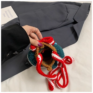 Detail of hand-knitted Christmas tree bucket bag with drawstring and striped strap