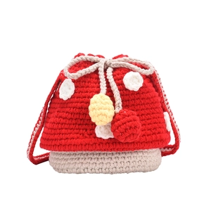 Handmade crochet mushroom drawstring bucket bag for kids with red and white knit patterns