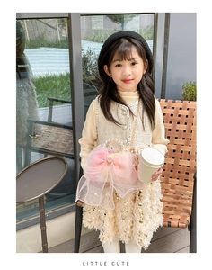 Detail of pink organza bow bag and white tweed dress set with pearl buttons for girls