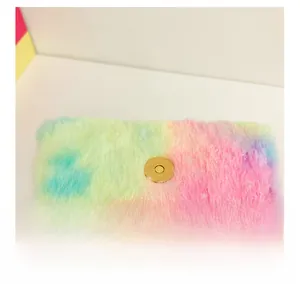 Detail of glitter star plush bag with golden magnetic snap closure and rainbow faux fur