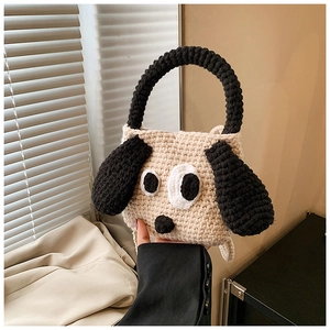 Close-up of handmade crochet dog bag featuring 3D ears and large cartoon eyes detail
