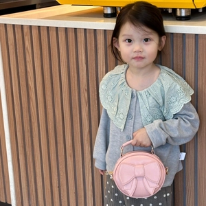 Pink round mini handbag for children with large decorative bow and top handle