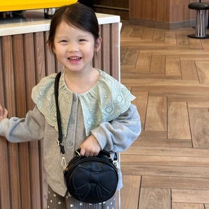 Kids mini round crossbody bag in black PU leather with large decorative bow detail