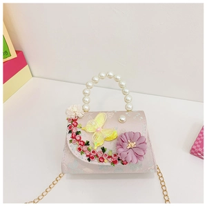 Close-up of pink girls' floral embroidery bag with pearl handle and metal chain detail