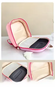 Detail showing the inner compartments and pink wing design of this kids backpack