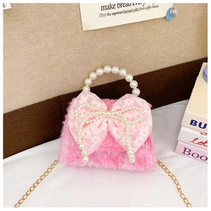 Detail of pink plush girls' mini bag with lace bow and elegant pearl top handle