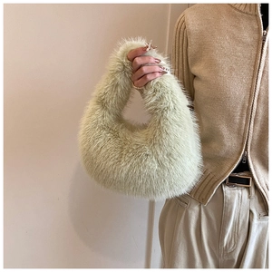 Détail de la texture en fausse fourrure douce et de l'anse de ce sac à main vert clair
