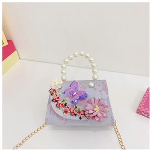 Detail of lavender floral kids bag with pearl handle and embroidered butterfly 3D flowers