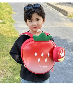 Detail of the strawberry hard shell backpack with matching round pouch and leaf design