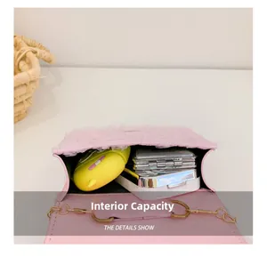 Internal view of pink lace crossbody bag showing capacity for earphones and makeup