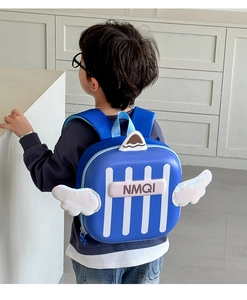 Detail view of a blue hardshell kids backpack with sequined white wings and stripe pattern
