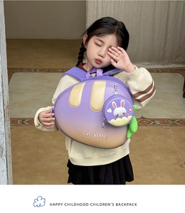 Detail view of cute purple bunny backpack featuring a detachable round coin purse charm