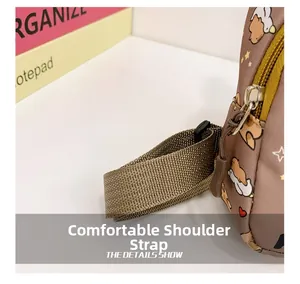Detail of adjustable woven shoulder strap and metal zipper on cute cartoon crossbody bag