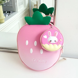 Close-up of strawberry-shaped backpack with cute bunny coin purse on white background