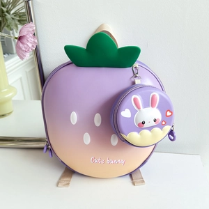 Detail of strawberry shaped backpack with gradient colors and cute bunny coin purse