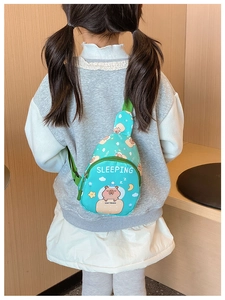 Detail of mint green kids crossbody bag with cartoon capybara print and nylon strap