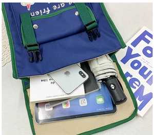 Macro view of interior storage capacity in the blue and green canvas children's backpack