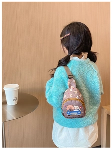 Detailed back view of a child wearing a brown capybara print chest bag with adjustable strap
