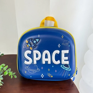 Detail of blue space rocket backpack featuring 3D Space letters and cartoon planets