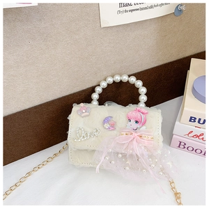 Detailed view of kids crossbody bag featuring pearl handle and cartoon girl pendant