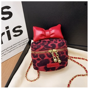 Detail of red leopard print mini chain bag with leather bow and golden zipper puller