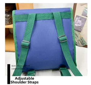 Detail view of adjustable green shoulder straps with black buckles on a blue kids backpack