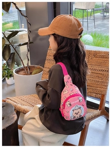 Pink cartoon Capybara kids chest bag with printed patterns worn by a child model