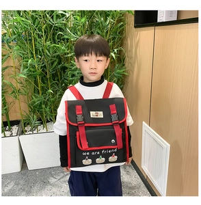 Close-up of kids backpack with contrast color design, buckle closure and cute bear patches