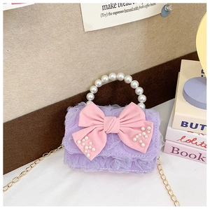 Detail of lavender lace children bag with large pink pearl bow and pearl handle