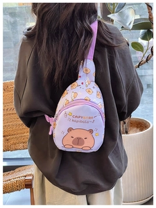 Detail of purple Capybara crossbody bag with adjustable strap worn by a child