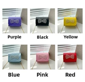 Mini girls crossbody bag with pearl bow decoration in six assorted vibrant colors
