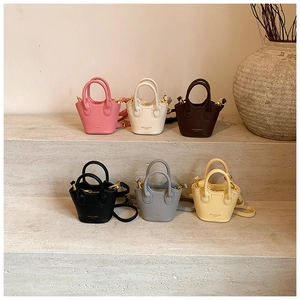 Detail showing variety of mini lychee textured crossbody bags in six different pastel colors