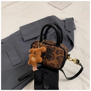 Detail of leopard print mini bag with plush bear charm and metallic IR letter logo