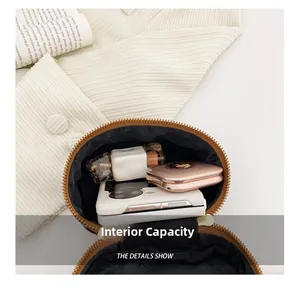 Detail showing the internal capacity of the brown round crossbody bag for kids
