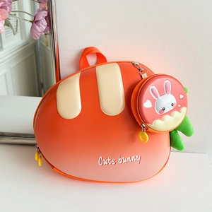Detail of cute carrot shaped hardshell backpack for kids with a small bunny coin purse