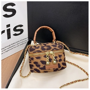 Detail view of mini leopard print plush bag with gold chain and double metal zippers