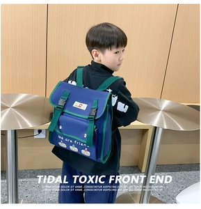 Detail of blue and green contrast kids backpack with cartoon design and double buckle closure