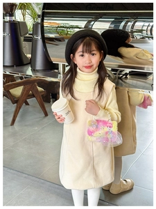Detail of plush girl mini handbag with pearl handle paired with autumn dress