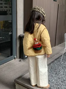 Handmade crochet child cross-body bag featuring a cartoon character with big red lips