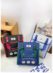 Detailed view of kids cartoon bear backpacks in red, blue, and grey color options