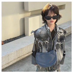 Blue nylon crescent bag shown on a stylish child model for high-fashion street style