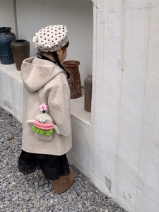 Cute crochet hamburger-shaped shoulder bag for kids paired with a chic winter outfit