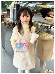 Detail view of colorful plush mini bag for kids with pearl handle and doll ornament