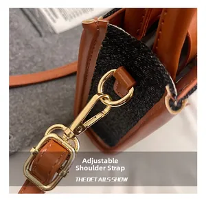 Close-up of adjustable gold buckle and brown leather strap on denim crossbody bag