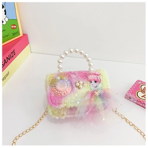 Detailed macro view of tie-dye plush kids handbag with pearl handle and 3D doll ornament