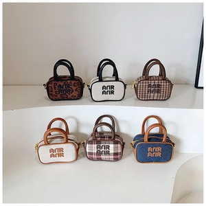 Detail view of plaid and leopard bowling bags with ARIR lettering and dual handles