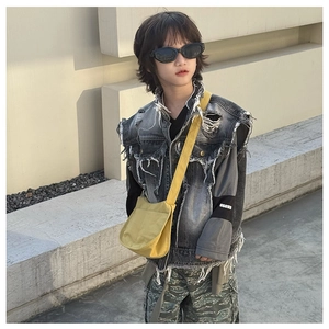 Street style kids outfit featuring a charcoal denim vest and bright yellow crossbody bag