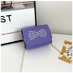 Detail of violet mini PU bag featuring a decorative pearl bow and gold chain strap