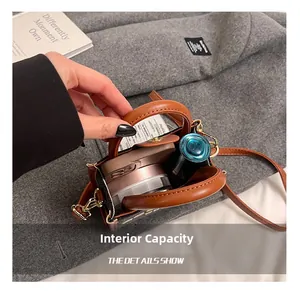Detail showing internal capacity of the brown mini crossbody bag with makeup items