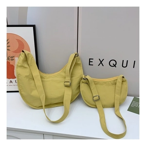 Size comparison of two yellow crescent nylon bags with adjustable straps in high-quality fabric